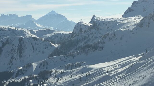 Endless Dolomites panorama in Dolomiti Superski. Snowy peaks, alpine valleys and breathtaking mountain views - a perfect slow travel moment in the Italian Alps