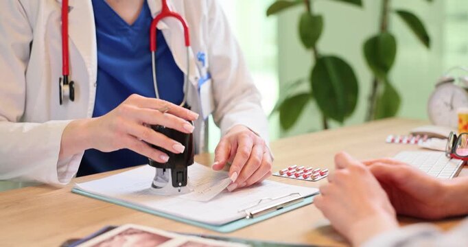Doctor applies stamp onto patient medical prescription in clinic office. Physician gives legal RX to woman at hospital appointment slow motion