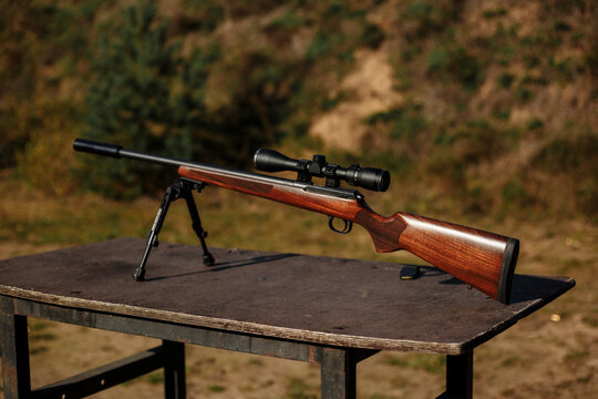 Shooting range. Precision Rifle with Scope and Bipod on Outdoor Table