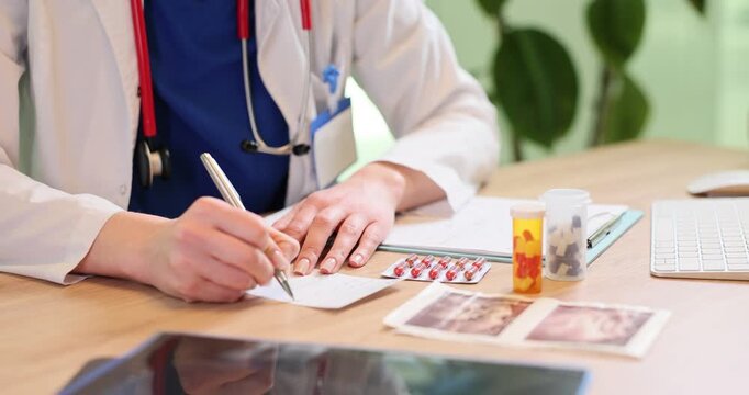 Woman medical worker writes pharmaceutical prescription in clinic. Woman doctor marks notes on paper sheet as listens to patient complaint in hospital