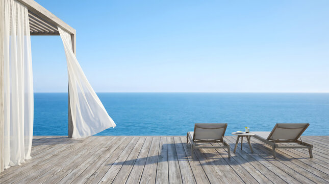 Wooden seaside terrace with white sheer curtains and lounge chairs under clear blue sky