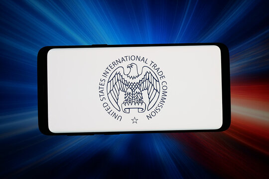 Stuttgart, Germany - 06-05-2026: In this photo illustration, the logo of U.S. International Trade Commission (USITC) is displayed on a smartphone in front of abstract background on computer screen.