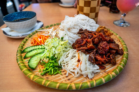 Vietnamese meal Bun cha on decorative plate on table.