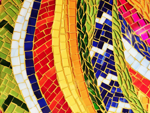 Close-up of a colorful mosaic made of ceramic fragments. Abstract texture, decorative art, handmade craftsmanship, detailed mosaic pattern.