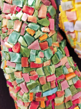 Close-up of a colorful mosaic made of ceramic fragments. Abstract texture, decorative art, handmade craftsmanship, detailed mosaic pattern.
