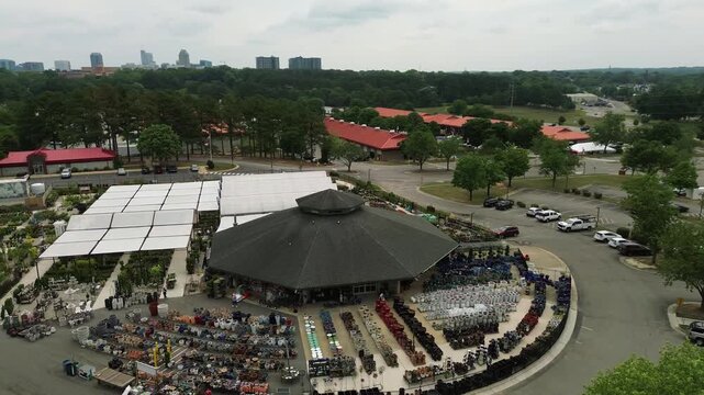 Aerial view of the North Carolina State Farmer's Market in Raleigh, with the city skyline in the distance