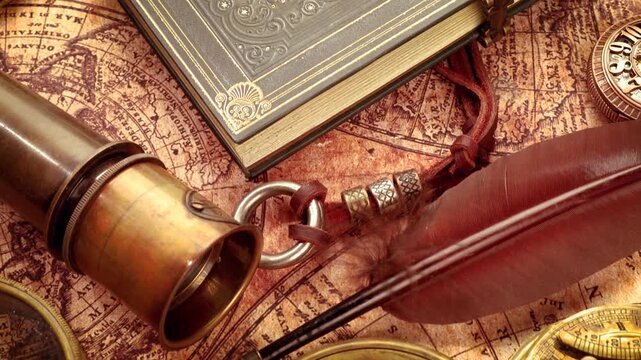 Vintage style close up of ancient compass, magnifying glass, quill pen, and diary with antique world map on a motion background.