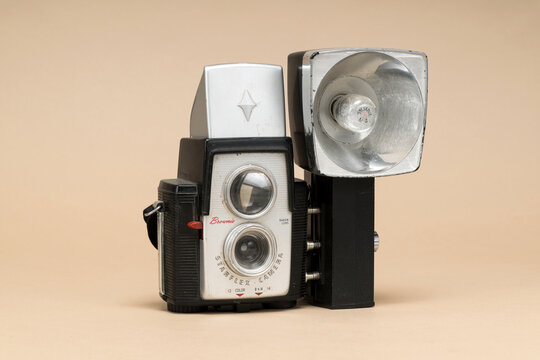 Kodak Brownie Starflex 1957 Vintage Camera with Sylvania M2 Flash &mdash; Mid-Century Film Camera on Beige Background