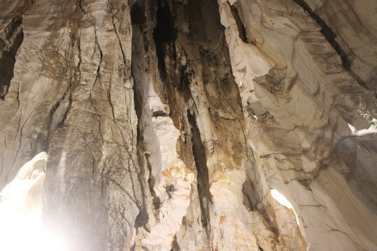 Natural cave rock formations with dramatic lighting and geological textures.