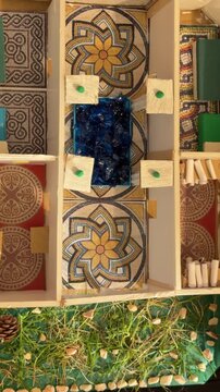Madrid, Spain, June 9-2026: Overhead view of a handmade Roman house model with mosaic-style floors, courtyard, rooms, and decorative elements, created as an educational school history project.