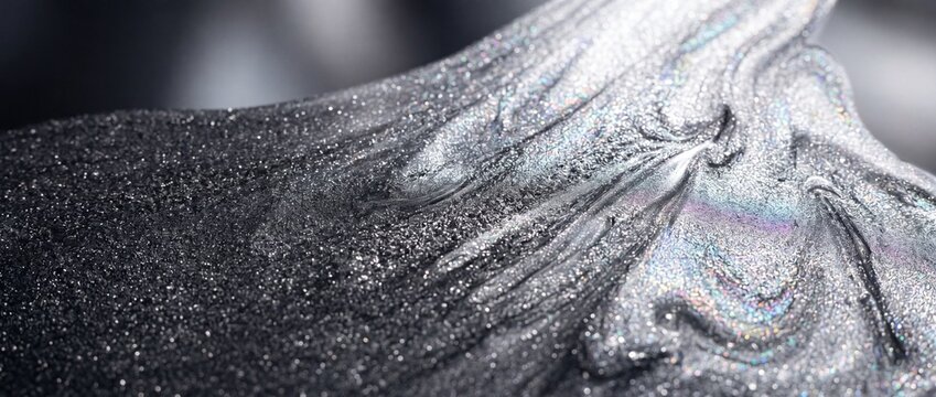abstract liquid metal dust gradient, flowing transition from graphite gray to iridescent silver, micro particle grain texture