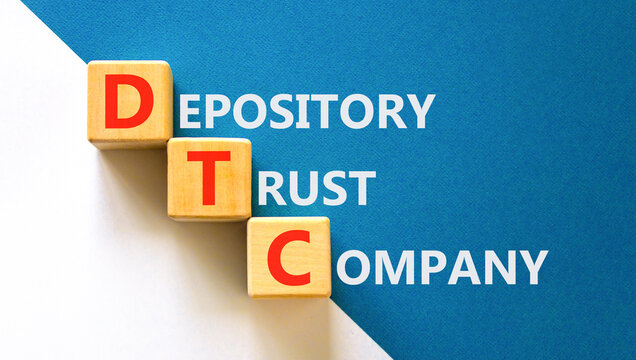 DTC depository trust company symbol. Concept words DTC depository trust company on beautiful wooden cubes. Beautiful white blue background. Business DTC depository trust company concept. Copy space.