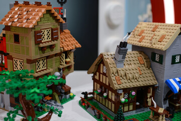 Naklejka premium Houses made of Lego bricks against a background of colorful houses made of Lego bricks. Poland. Warsaw.