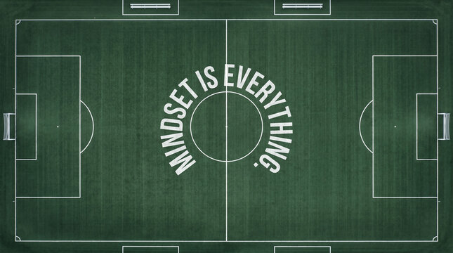 Overhead view of soccer field with mindset is everything text