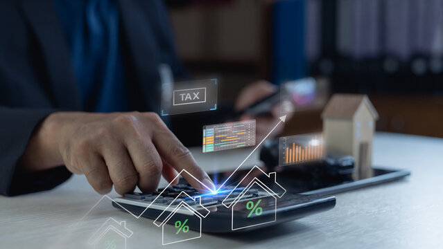 gst vat tax taxes finance accounting accountant business payment.Business professional calculating property tax, mortgage and GST/VAT with digital finance dashboard, growth chart and house model.