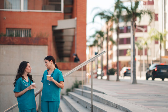Healthcare workers taking a moment to relax and chat outside the hospital premises during their break time