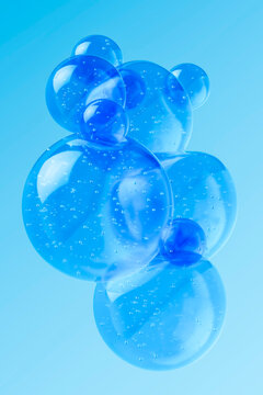 Floating 3D glass bubbles in blue liquid with smooth reflections on background