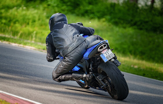 Regular training in Riga, Latvia, Bikernieki on 12-05-2026  Motorcyclist leaning into a turn on a winding road