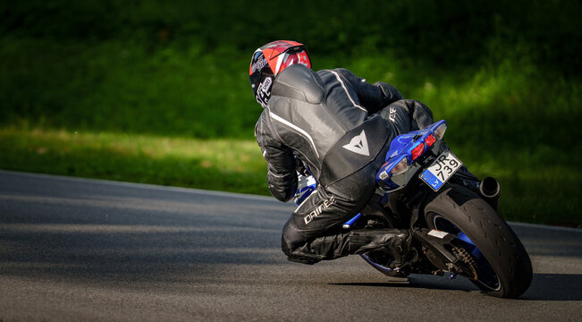 Regular training in Riga, Latvia, Bikernieki on 12-05-2026  Motorcyclist leaning into a turn on paved road