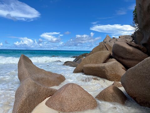 The beautiful Grand Ance Beach on La Digue Island in the Seychelles. Turquoise sea, waves, huge cliffs, white sand