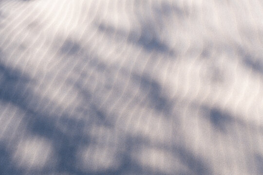 Sand with subtle, wavy patterns and shadows cast on its surface. Karwienskie Blota beach. Baltic Sea. Karwia. Poland