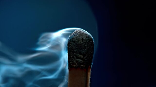 Burning match ignites and extinguishes in slow motion close up footage
