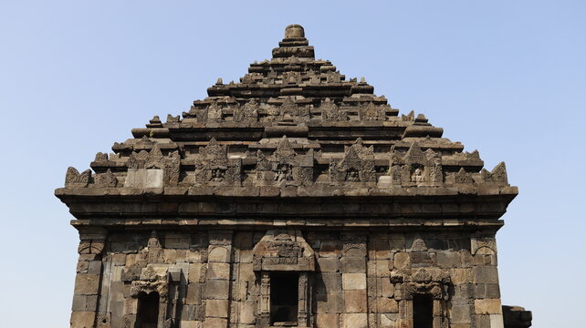 Close-up architectural details of ancient stone temple roof structures in Prambanan, Indonesia