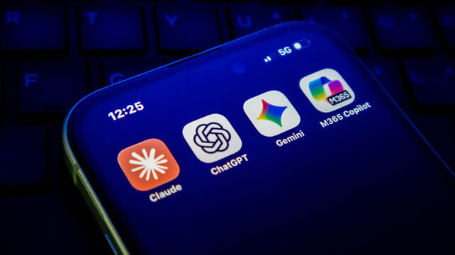 Closeup of a smartphone screen displaying popular artificial intelligence application icons including claude, chatgpt, gemini, and microsoft 365 copilot