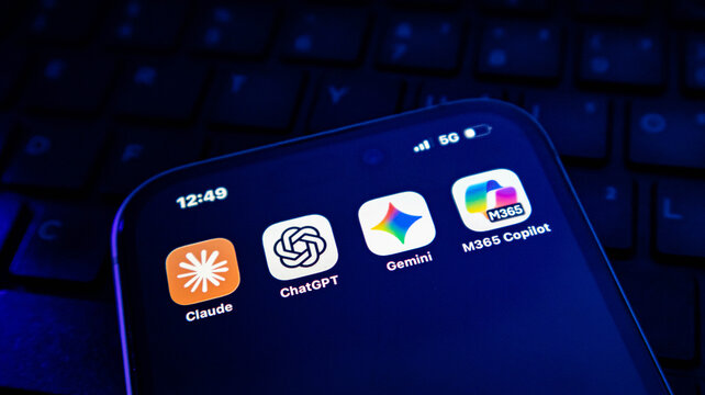 Smartphone screen displaying various artificial intelligence mobile application icons including claude, chatgpt, gemini, and m365 copilot