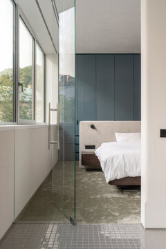 Bedroom and bathroom connection with glass wall