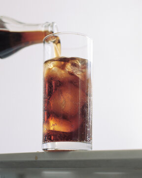 Fresh and cold sparkling beverage pouring in a glass 