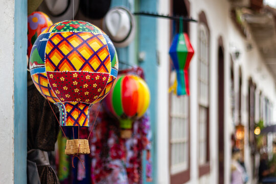 Colorful traditional paper hot air balloon decorations hanging outside a colonial building in Paraty Brazil