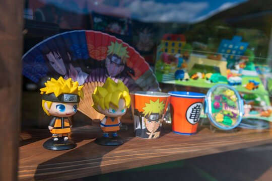 Naruto and Son Goku figures on shelf at souvenir store, Yufuin