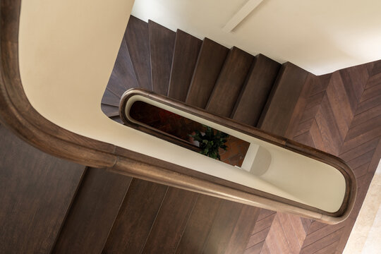 Top view of wooden staircase with curved rail