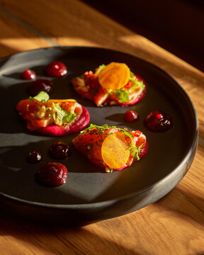 Gourmet Crostini Appetizers on Dark Plate with Moody Lighting