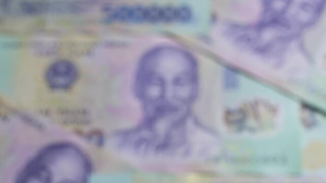 Vietnamese currency note with portrait of Ho Chi Minh with changing selective focus. Concept of saving money, cash payments, financial literacy, Vietnam economy.