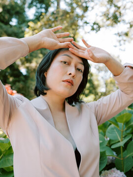 Non-binary model in pink blazer
