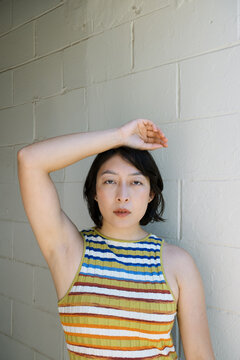 Non-binary person in striped multi-colored dress