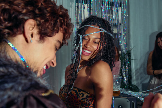 Friends smiling together during intimate nightlife moment