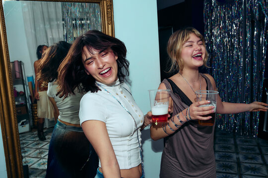 Friends dancing and laughing at Gen Z house party
