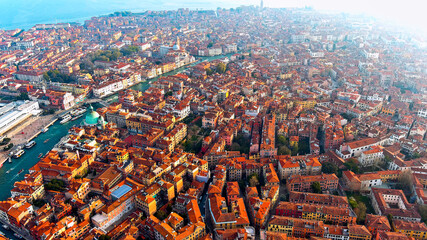 Obraz premium Aerial drone view of Venice historic terracotta rooftops, dense Renaissance architecture and canals, Venice, Veneto, Italy