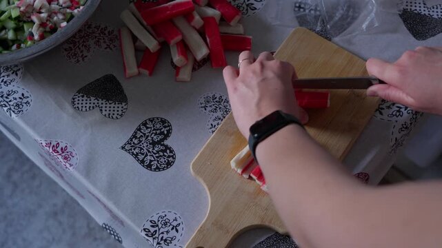 Preparing Surimi Sticks by Cutting Them Into Small Pieces