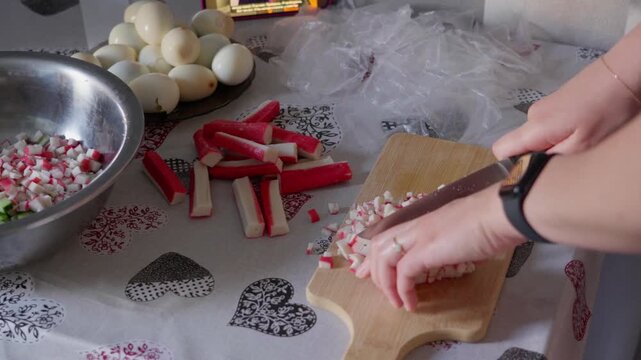 Finely Chopping Surimi on Wooden Cutting Board
