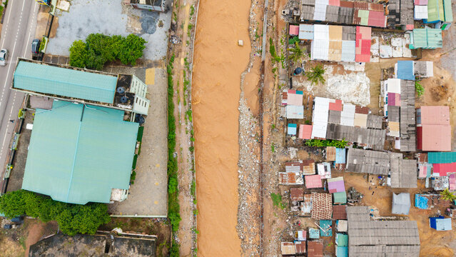 Aerial view, Widespread flooding in Accra, Ghana, with muddy floodwater overflowing a storm drainage channel after intense rainfall