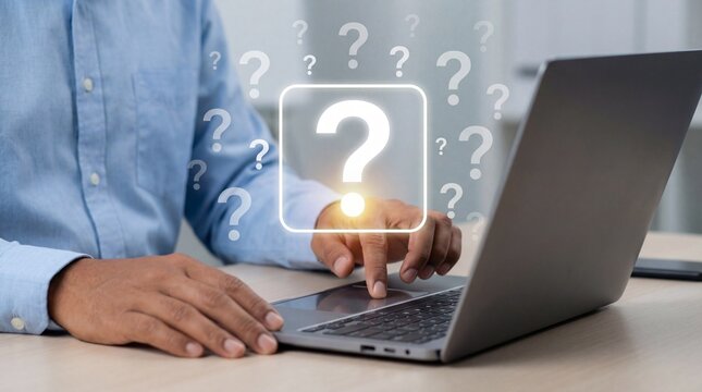 Curious cat sitting near laptop with question marks floating above, showcasing digital kitty while thinking for modern cats