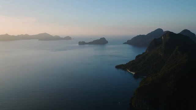 Sunset over Helicopter Island in El Nido. Tropical Islands at dusk time in Palawan, Philippines.
