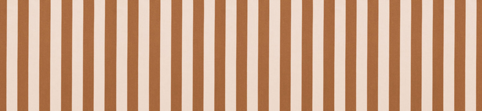 Seamless pattern of vertical caramel brown and white textile stripes on textured awning fabric background