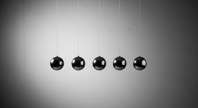 Glossy Metal Pendulum Balls Hanging in Balanced Row on Gray Background