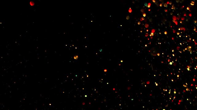 Gold dust particles fly in slow motion in the air lingering slowly. Dust Particles Background Bokeh Lights Background on Black Background 4k Footage Snow Particles Background.