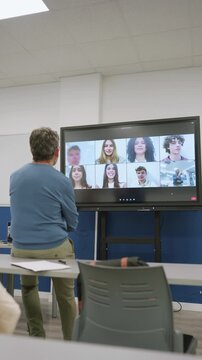 Teacher conducting online video call lesson with students